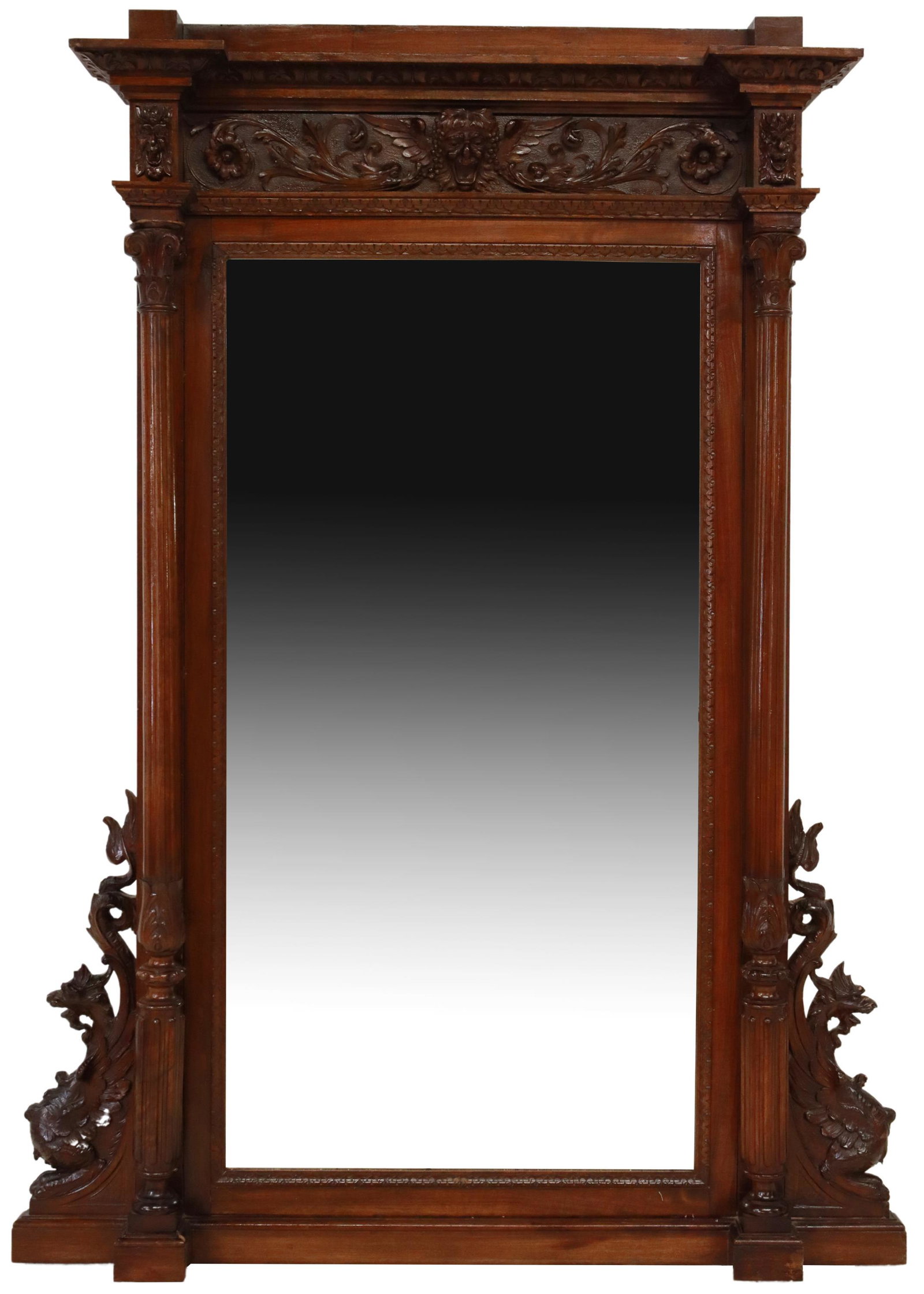 ITALIAN RENAISSANCE REVIVAL CARVED WALNUT MIRROR: Italian Renaissance Revival walnut mirror, 19th c., having stepped cornice, over central winged mask of Bacchus, above beveled mirror plate, flanked by fluted corinthian columns, rising on base flanke