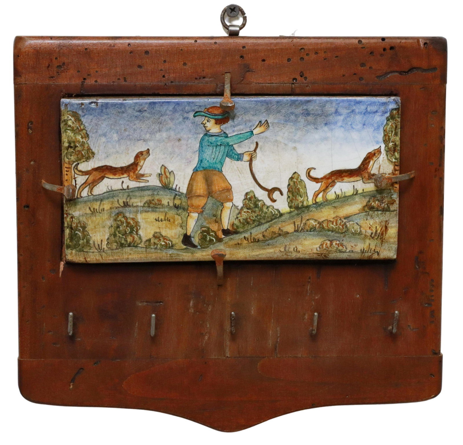 FRENCH FAIENCE PLAQUE WALL-MOUNTED WOOD KEY RACK: French faience wall-mounted key rack, painted ceramic tile with figural dog hunting scene, mounted on shaped wood plaque, with five key hooks, approx 10"h, 10.5"w, 2"d, 1.8lbs Start Price: $50.00