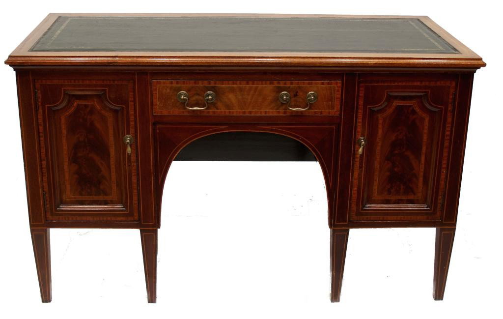 EDWARDIAN FLAME MAHOGANY BANDED LADIES DESK: English Edwardian banded mahogany lady's desk, early 19th c., the rectangular top having inset green leather writing surface embossed and with remnants of gilding, above a single drawer, arched kneeho