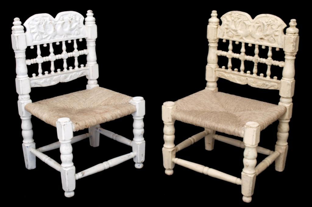 ANTIQUE SPANISH CARAVED BACK PAINTED PINE CHAIRS: (pair) Primitive Spanish pine framed rush seat chairs, Barcelona, c. 1900, short backs with floral carved crest rail, spindles, turned legs joined by stretchers, multiple coats of paint producing slig