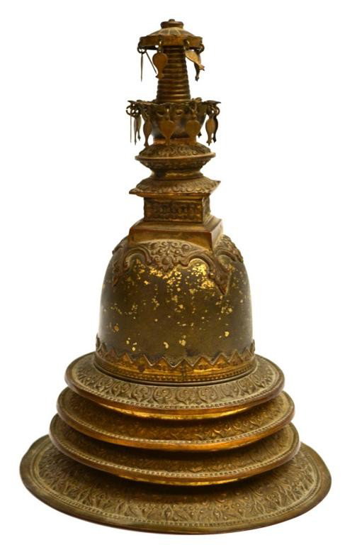 19TH C HIMALAYAN GILT METAL STUPA (CHORTAN): Himalayan gilt metal model of a stupa (chorten), 19th c., with the reliquary mound raised on a four-tier base with foliate-pattern repousse decoration repeated on the harmika [upper box-like structure
