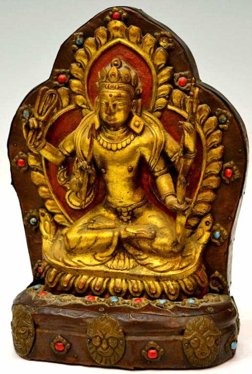 HIMALAYAN / TIBETAN GILT COPPER BUDDHIST DEITY: Himalayan/Tibetan gilt copper over wood figure of a Buddhist deity, 19th/early 20th c., wearing bodhisattva raiment and seated in a pose of meditation with each of the four arms with an attribute (noo