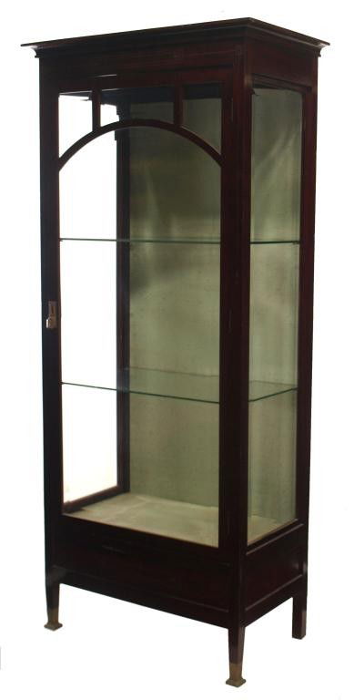 SPANISH ART NOUVEAU MAHOGANY VITRINE: Spanish Art Nouveau mahogany finish display cabinet, Barcelona, c. 1900, rectangular form with beveled glass panels, a single door over upholstered interior with two glass shelves, brass inlay accents