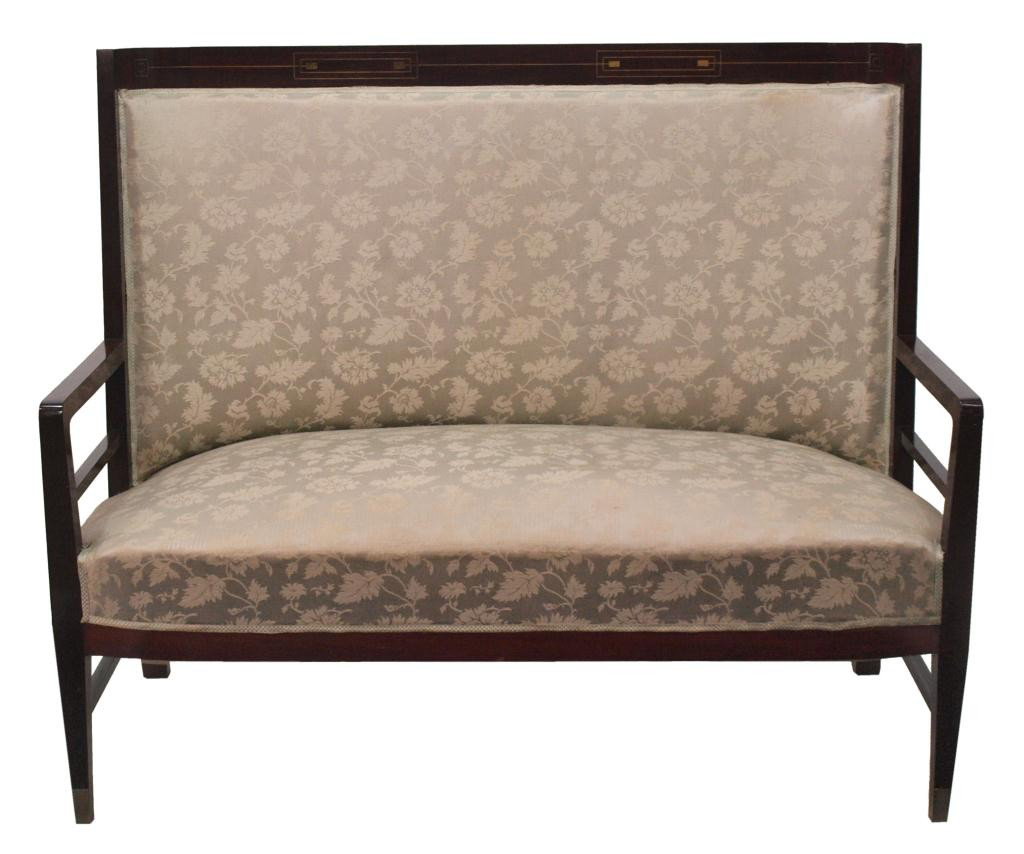 SPANISH ART NOUVEAU MAHOGANY FRAMED SETTEE: Spanish Art Nouveau mahogany barrel back settee, Barcelona, c. 1900, the crest rail with metal inlay, light gray brocaded upholstery with silver floral and foliate decoration with stains, resting on s