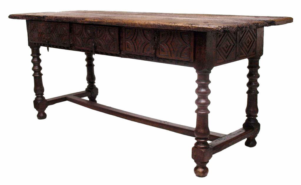 ANTIQUE RUSTIC THREE DRAWER TABLE, 17TH C ELEMENTS: Spanish oak table composed of 17th c. elements, a rectangular two board top joined to the base by large spikes, three drawers rising on turned legs with drawer faces and skirt having geometric carving