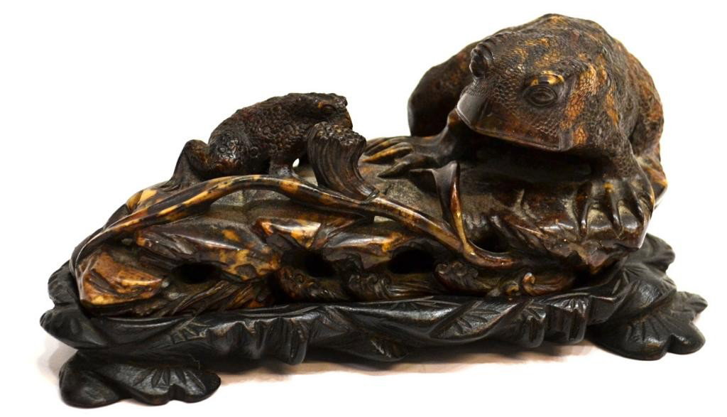 CHINESE SOAPSTONE FROG CARVING, QING / REPUBLIC: Chinese soapstone/steatite figural carving, Qing/Republic period, well carved as two toads climbing on a lotus leaf with a seed pod to the front, the realistic tableau incorporating the mottled yellow