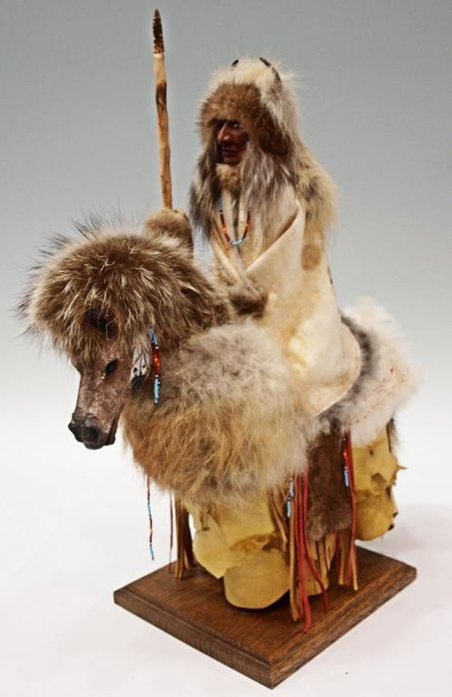 NORTH AMERICAN FIGURE, INDIAN ON HORSEBACK, CANADA: Native North American made Indian on Horseback, c. 2004, Quebec City, Canada, by unknown Iroquois tribe member, rider wrapped in tanned white hide, the whole with raccoon hair, 19"h, 8"w, 15"d, 5lbs S
