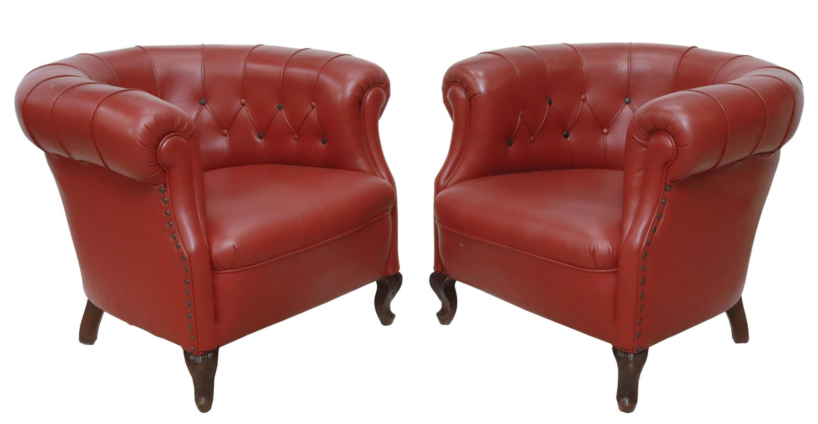 (2) CHESTERFIELD STYLE BARREL LEATHER ARMCHAIRS: (pair) Chesterfield style armchairs, 20th c., in leather upholstery, with rolled button-tufted back and arms, nailhead trim, rising on cabriole legs, ending in whorl feet, approx 27"h, 34"w, 33"d, sea