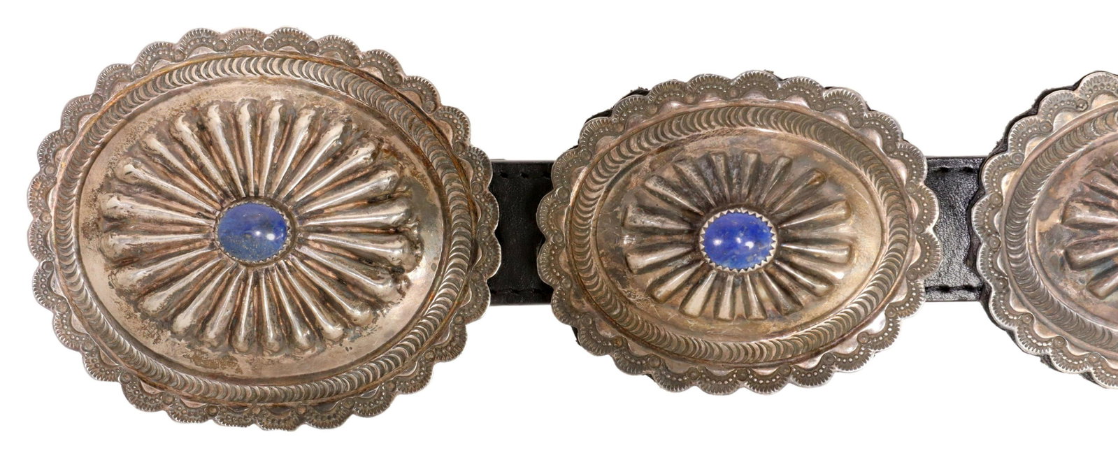NAVAJO ALFRED MARTINEZ STERLING LAPIS CONCHO BELT: Native American sterling silver concho belt, buckle signed AM (Alfred Martinez, Navajo, 20thc.), oval buckle and ten matched conchos, each with central blue lapis cabochon within serrated bezel, stamp