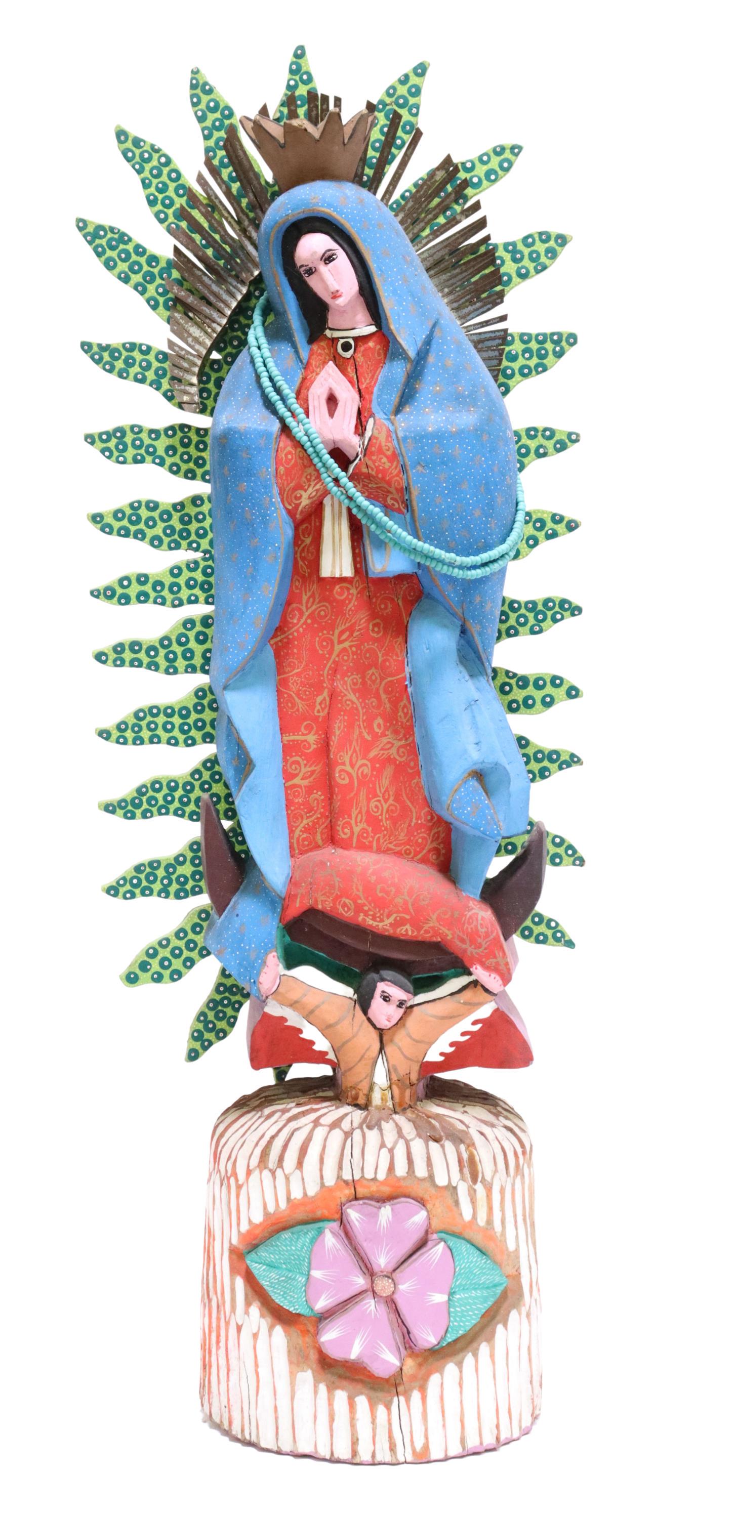 ANITA G. MENDOZA LADY OF GUADALUPE STATUE, MEXICO: Folk art carved wood religious figure, Our Lady of Guadalupe, signed Anita Gomez Mendoza, Mexico, polychrome painted with metal aureole, accented with blue beaded necklace, rising on floral base, appr