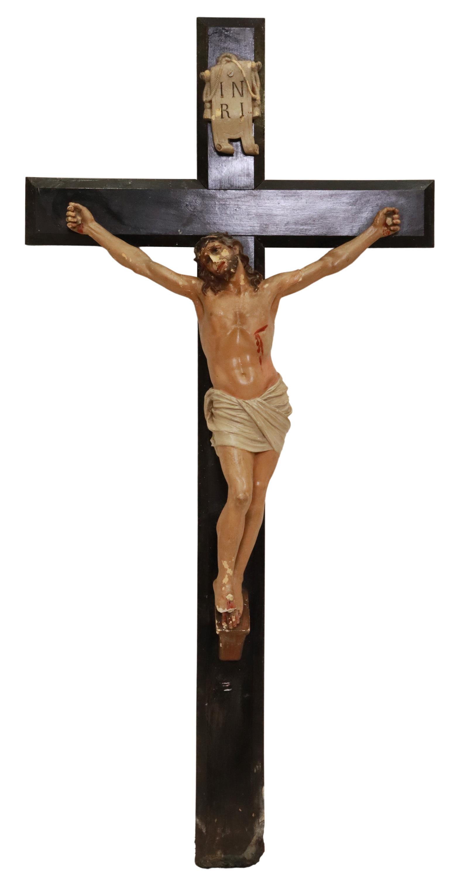 LARGE RELIGIOUS CARVED WOOD & GESSO CRUCIFIX: Large religious crucifix, 19th c., polychrome painted crucified Christ, gesso figure, ebonized chamfered cross, some loss to Christ figure and lower wood cross, approx 45.5"h, 22"w, 5"d, 9lbs Start Pr