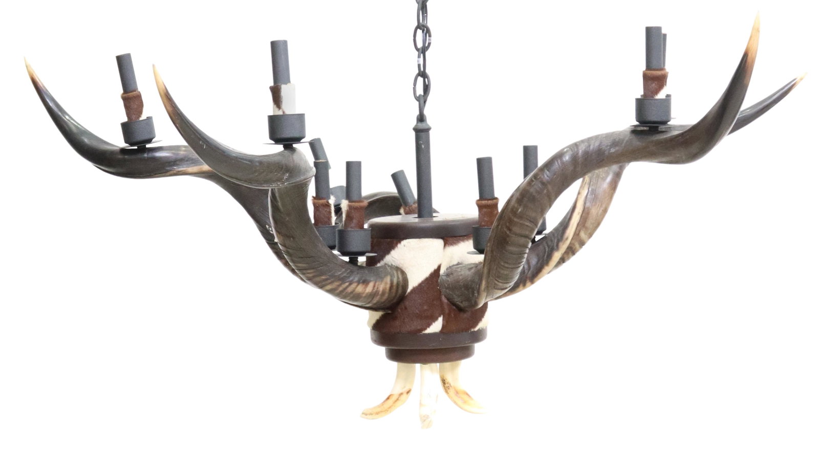 CUSTOM RUSTIC HIDE & KUDU HORN 10-LIGHT CHANDELIER: Custom ten-light chandelier, Frank Long & Company, Bozeman, Montana, 21st c., hide-wrapped standard, issuing five kudu horns, surmounted by hide-wrapped faux candles, center drop with three tusks, in 