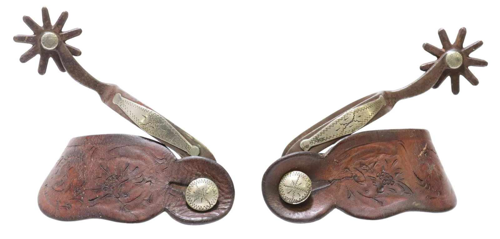 WESTERN TEXAS STYLE OSCAR CROCKETT SPURS: (pair) Western Texas style cowboy spurs, Oscar Crockett, patinated metal outside heelband mounted with silver embellishment, 1.5" rowels, nine points, worn tooled leather straps with silver button, ma