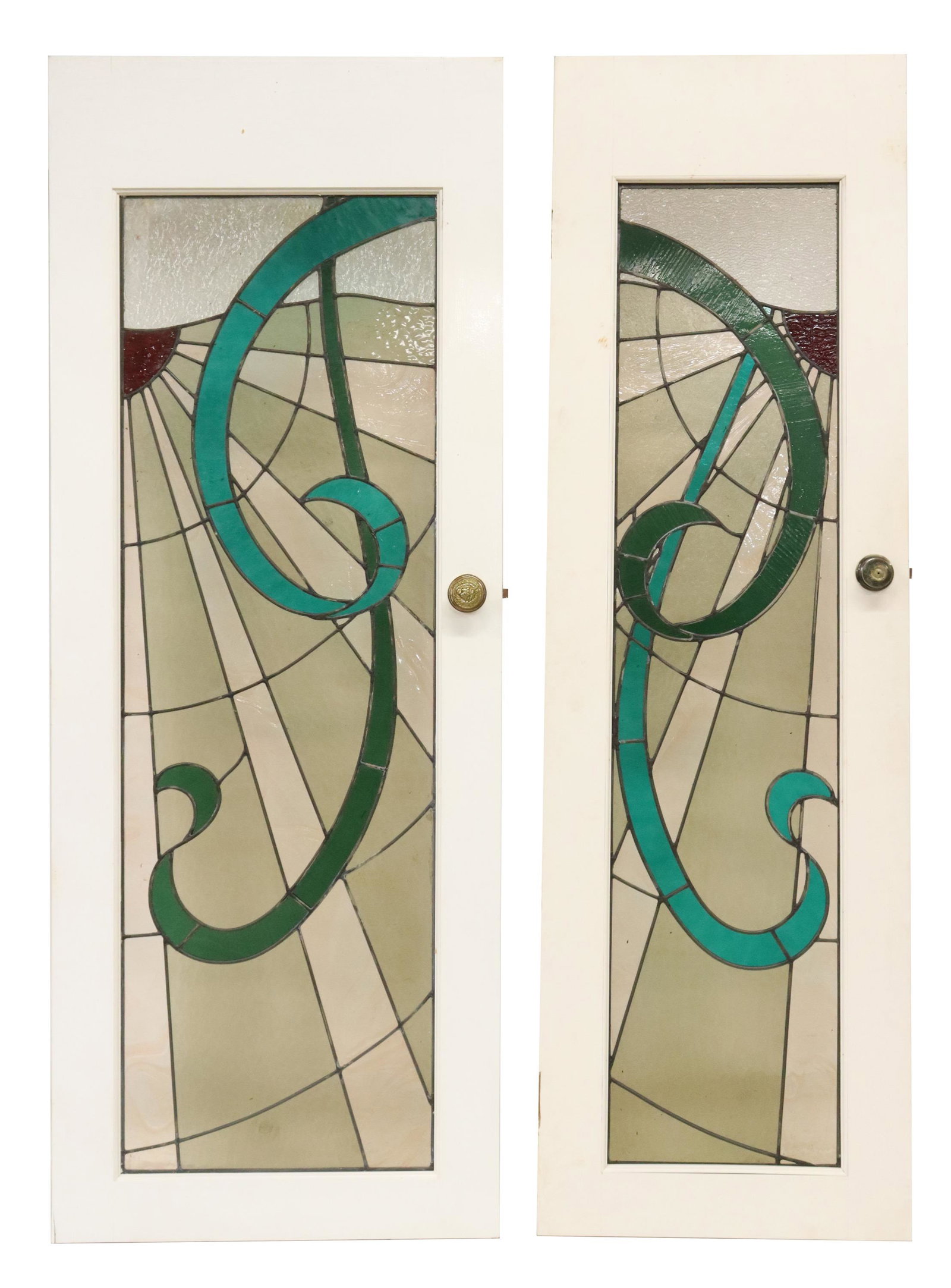 (2) SCROLLED DESIGN STAINED & LEADED GLASS DOORS: (lot of 2) Stained and leaded glass paneled doors, with frame in white paint: (1) approx 80.25"h, 24"w, 1.75"d; (1) approx 80.5"h, 30"w, 1.75"d Start Price: $150.00