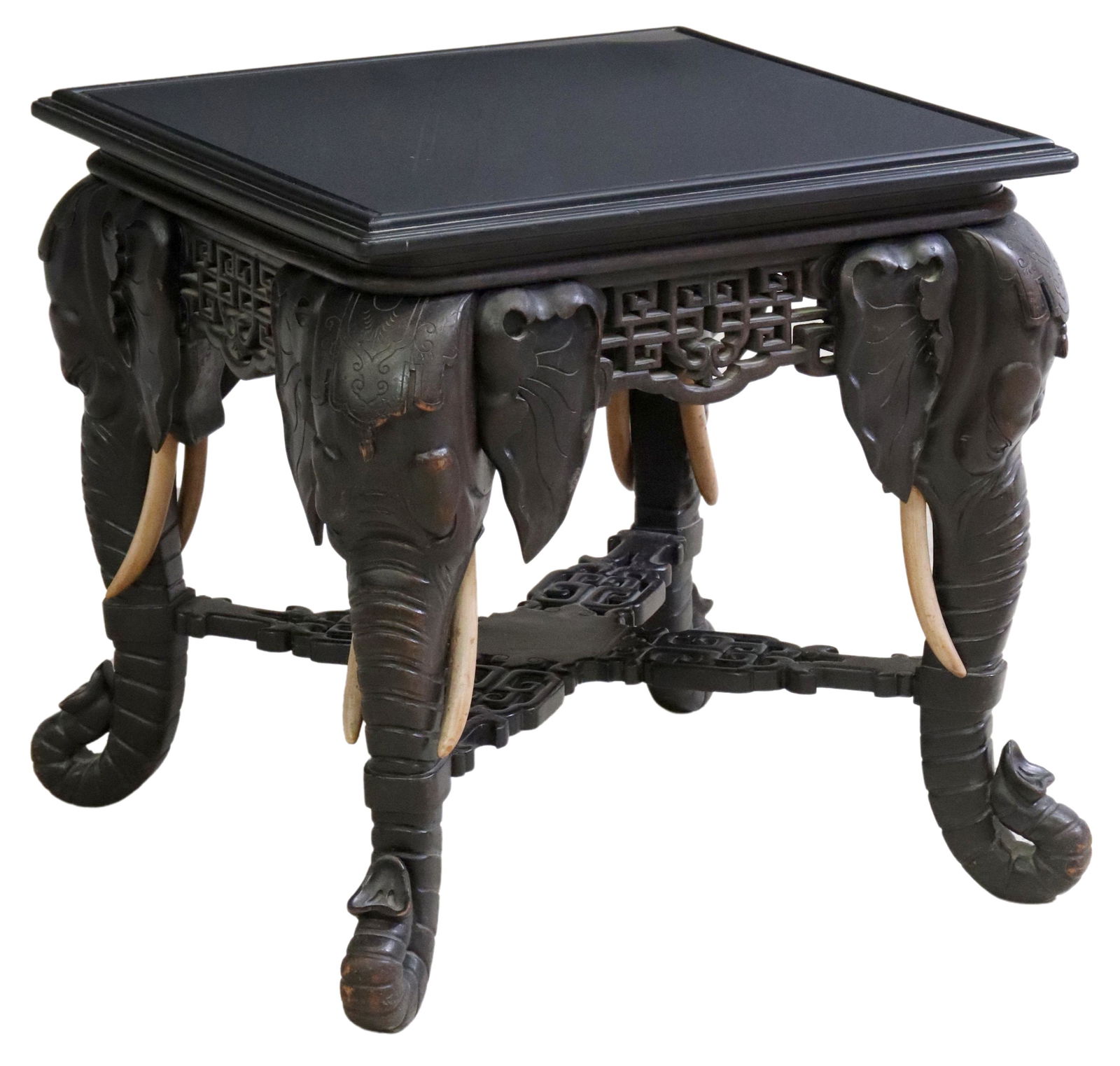 ASIAN GLASS-TOP EBONIZED ELEPHANT SIDE TABLE: Ebonized Asian elephant coffee table, 20th c., having inset glass top, over pierced fretwork apron, rising on elephant mask supports, joined with cross stretcher, approx 19.75"h, 21"sq Start Price: $2