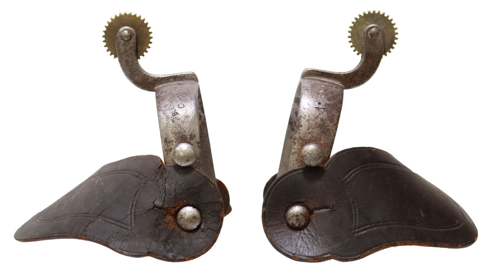 AUGUST BUERMANN 'OK' IRON COWBOY SPURS: (pair) Western cowboy spurs, August Buermann (1842-1928), engraved heelband with line and dot pattern, 1 1/8" rowels, worn leather straps, marked BUERMANN'S O.K. PAT'D on heelband, yoke: approx 3"w, 3