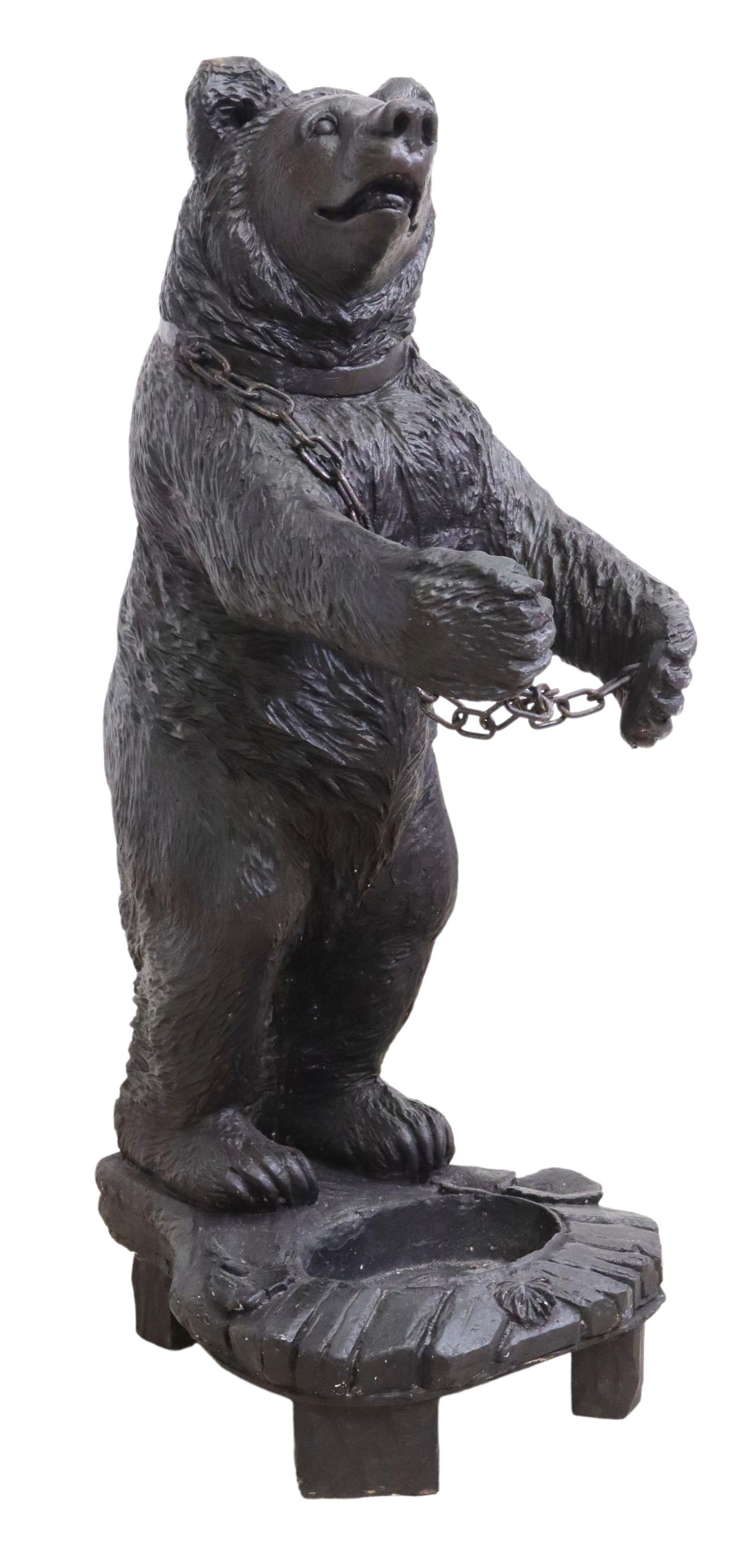 BLACK FOREST STYLE CAST RESIN BEAR UMBRELLA STAND: Black Forest style cast resin umbrella stand, 20th c., fashioned in the form of a bear, having chain link connecting paws, above faux wood basin, rising on block feet, approx 37.25"h, 14"w, 19"d Start
