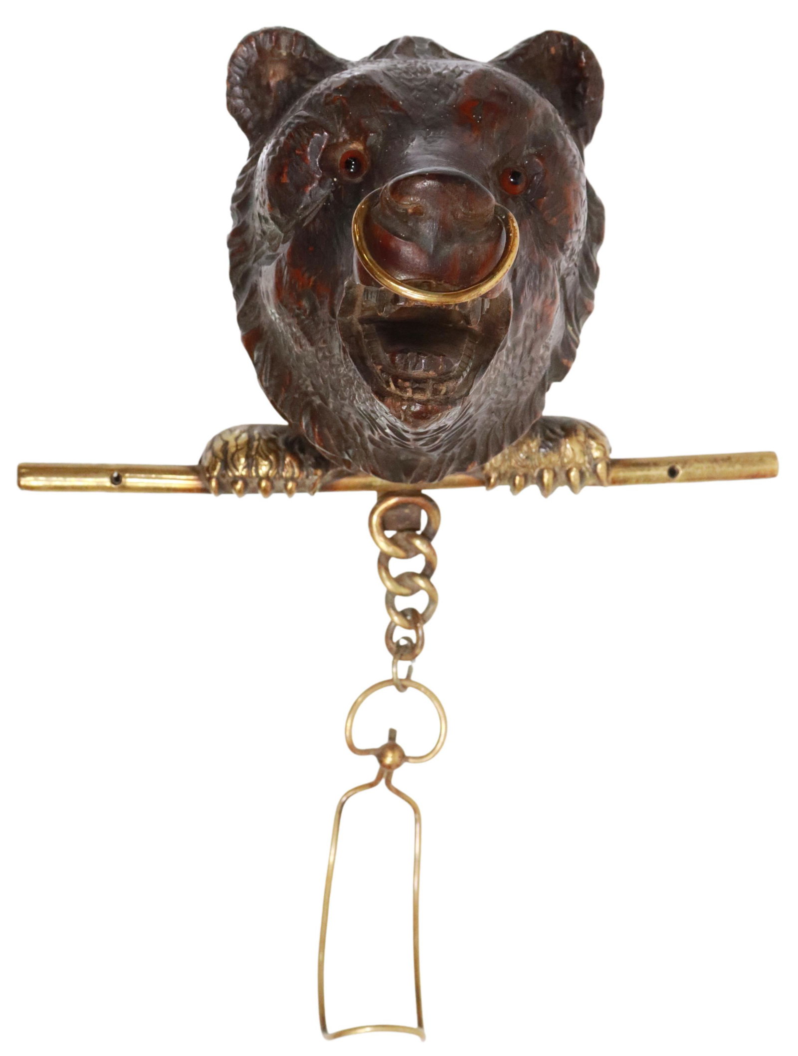 BLACK FOREST CARVED BEAR WALL-MOUNTED HANGER: Black Forest wall-mounted hanger, late 19th/ early 20th c., carved bear's head with inset glass eyes, brass paws supporting rod, chain drop with hook, approx 10.75"h, 8 1/8"w, 5.5"d, 1lbs Start Price: