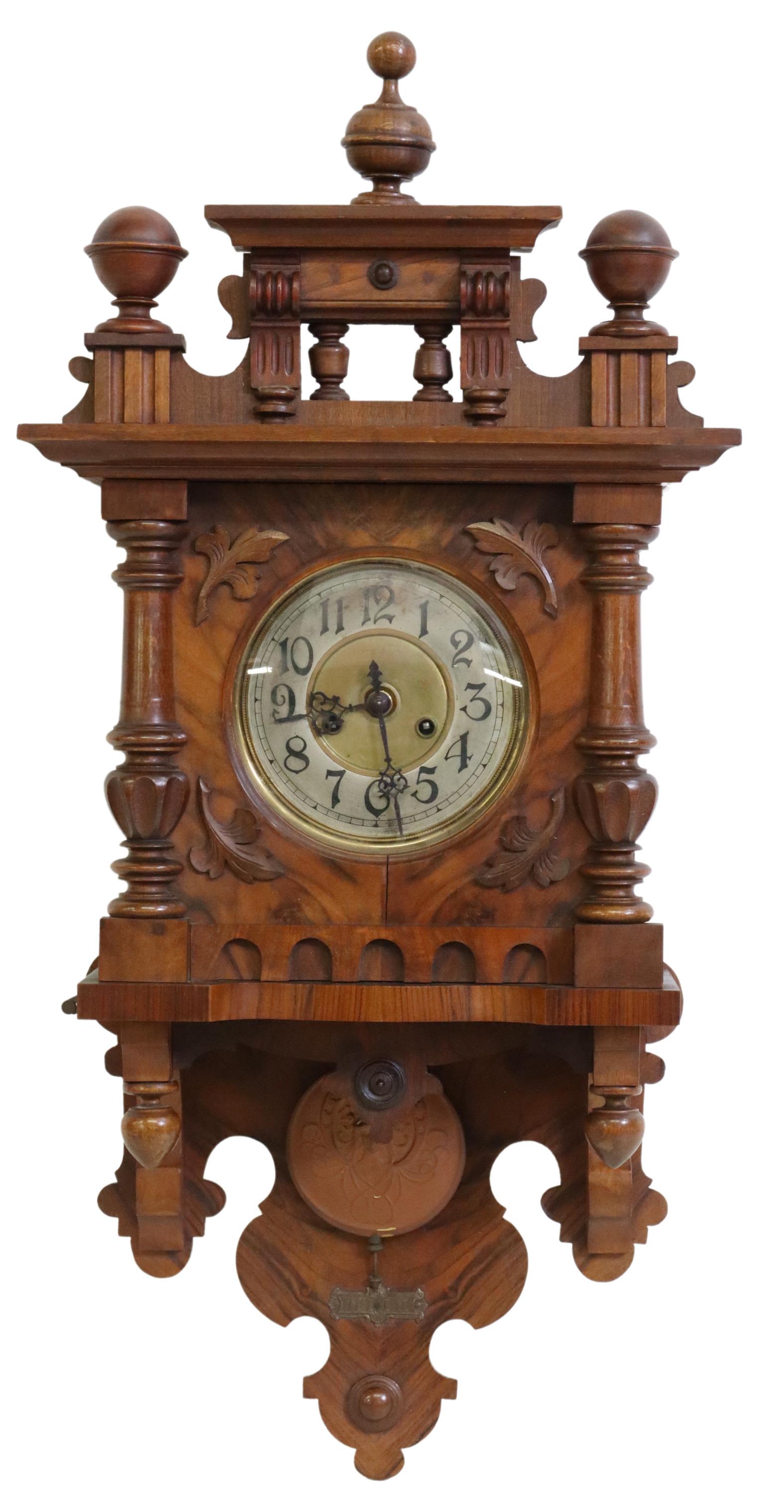 GERMAN GUSTAV BECKER WALNUT CASED WALL CLOCK: German walnut cased wall clock, Gustav Becker, late 19th c., crest with turned finials, brass dial with silvered chapter ring, Arabic numeral hour markers, time-and-strike movement, Dom gong, pendulum