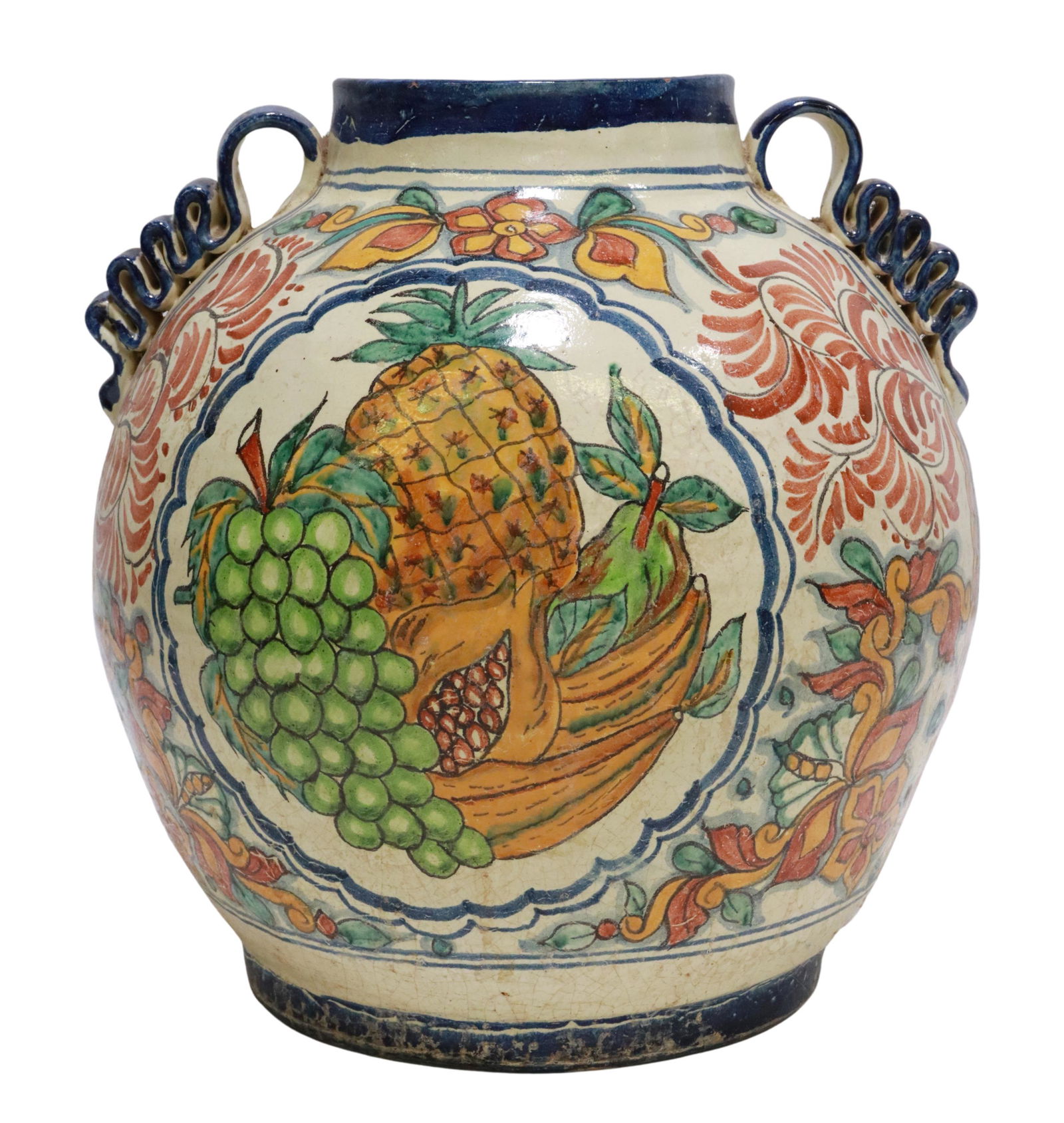 LARGE TALAVERA TIN-GLAZED EARTHENWARE JAR: Large Talavera tin-glazed earthenware jar, Mexico, with cobalt blue rim and ruffled handles, body ornamented in polychrome fruits and florals, large chip to one handle, approx 14.5"h, 13.65"diam, 15.7