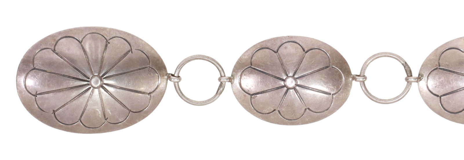 NAVAJO NEL J. STERLING SILVER CONCHO BELT: Native American sterling silver concho belt, signed Nel J. (Navajo, 20thc), buckle and oval links with stylized floral design, spaced by circular rings, belt: approx 36.5"l, 2.02ozt Start Price: $50.0
