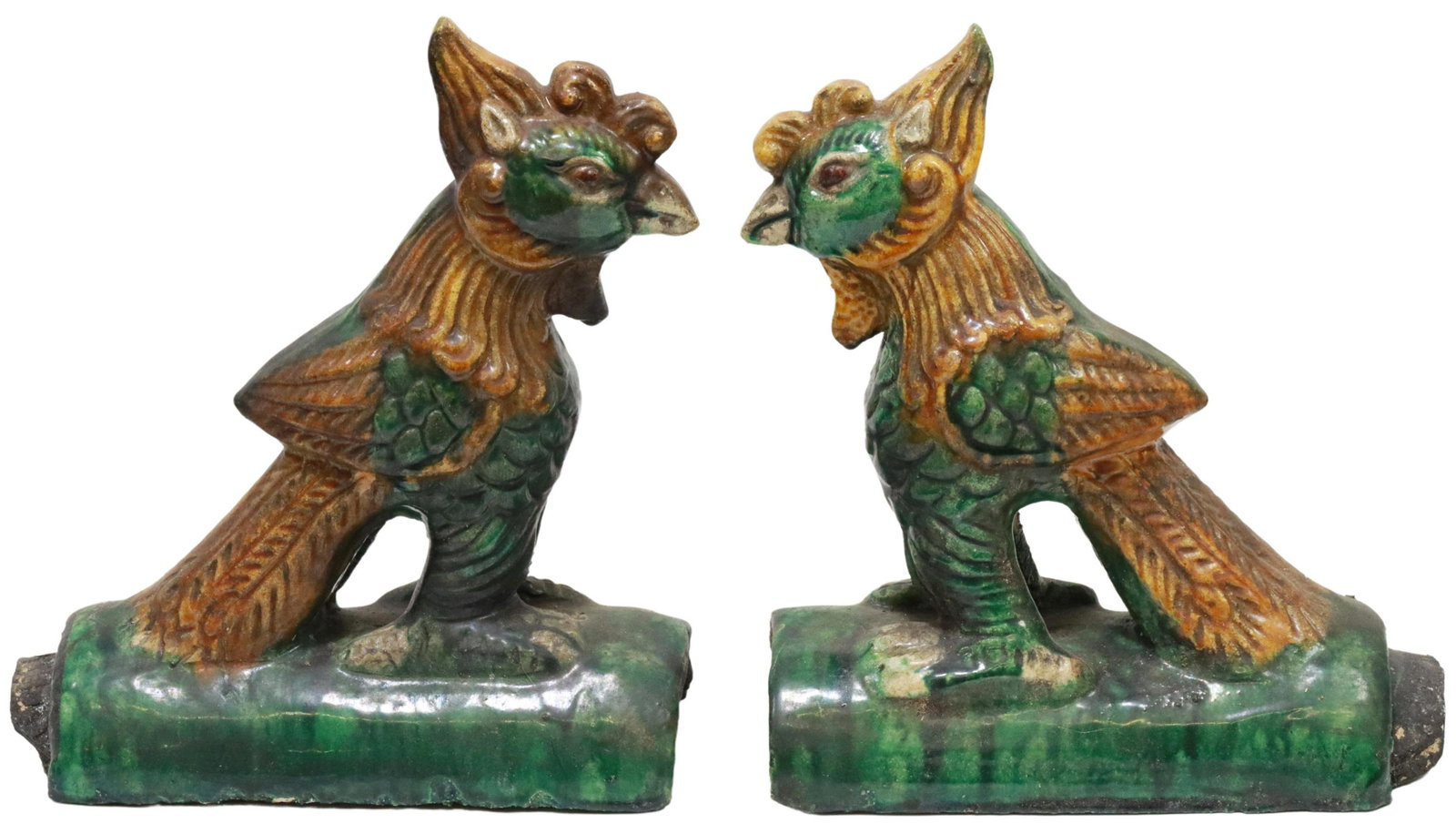 (2) CHINESE SANCAI GLAZED PHOENIX ROOF TILES: (lot of 2) Chinese ceramic roof tiles, glazed in a Sancai palette, modeled as phoenix, on integral arched bases, approx 10"h, 10"w, 4.5"d, 10.5lbs total Start Price: $125.00
