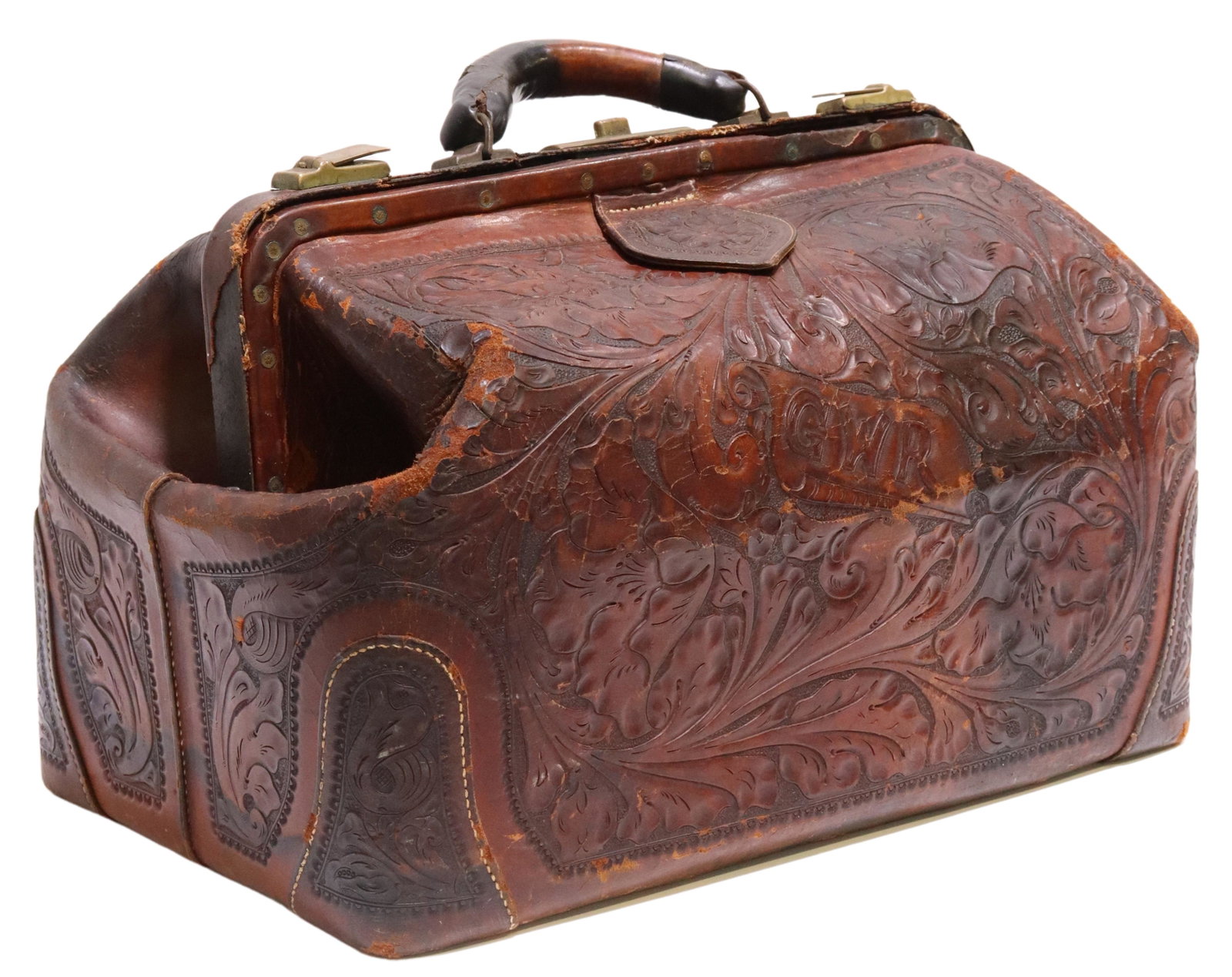 TOOLED LEATHER MONOGRAMMED TRAVELING DOCTOR'S BAG: Tooled leather traveling doctor's bag, having rolled top handle, gold-tone metal lock and clasps, scrolled foliate designs with central GWR monogram, light green leather lining with three interior sli