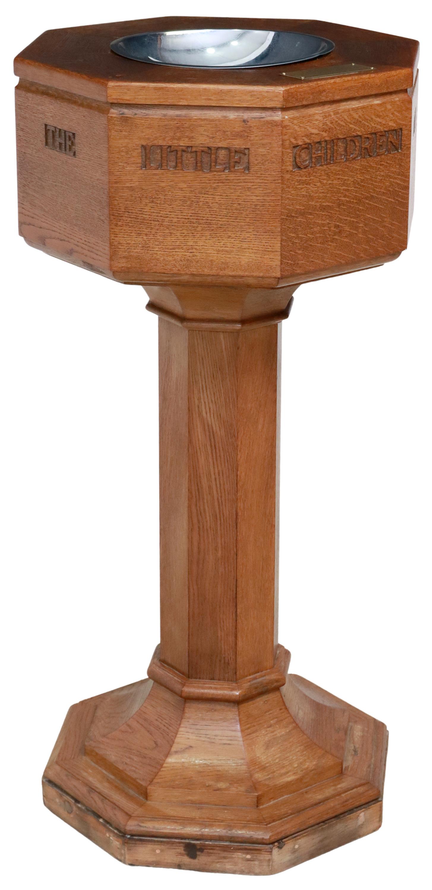 SCOTTISH CARVED OAK HOLY WATER FONT: Scottish oak holy water font, mid 20th c., octagonal form, inset metal dish, sides carved with the verse "suffer the little children to come unto me," pedestal base, brass dedication plaque reading: "