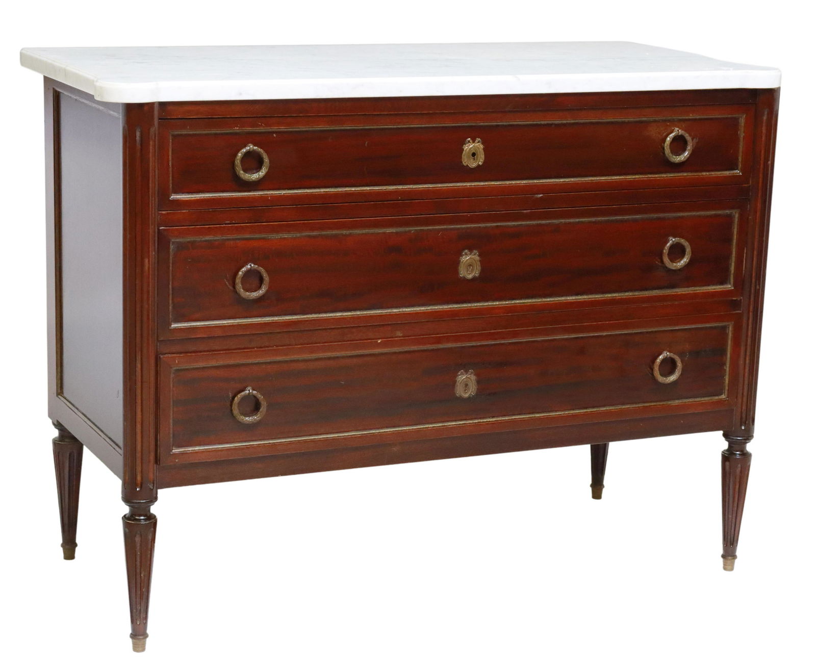 FRENCH LOUIS XVI STYLE MARBLE-TOP MAHOGANY COMMODE: French Louis XVI style mahogany commode, 20th c., having shaped marble top, over three drawers, with laurel wreath pulls, rising on fluted and tapered legs, ending on capped feet, approx 30.5"h, 40.75