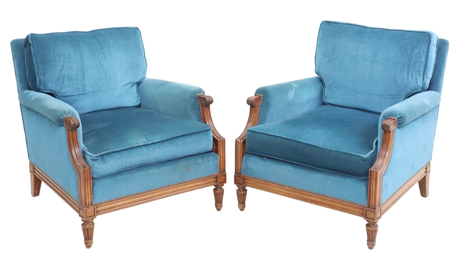 (2) FRENCH LOUIS XVI STYLE UPHOLSTERED BERGERES: (pair) French Louis XVI style armchairs, 20th c., in mohair upholstery, with loose back and seat cushions, scrolled handholds, rising on tapering fluted legs, some wear and spotting to upholstery, app