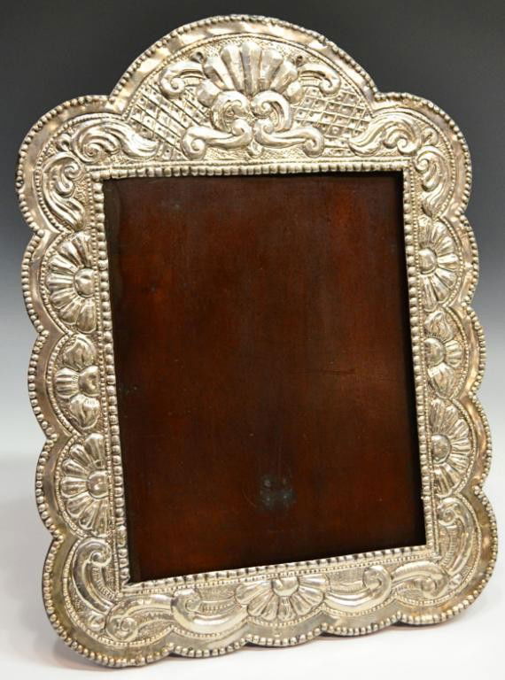 LARGE ANTIQUE REPOUSSE 900 SILVER PICTURE FRAME: Antique Spanish Colonial style 900 silver picture frame, the wood frame mounted with repousse 900 silver sheet in an elaborate foliated shell and scroll motif, marked MP in a diamond, 900, other parti