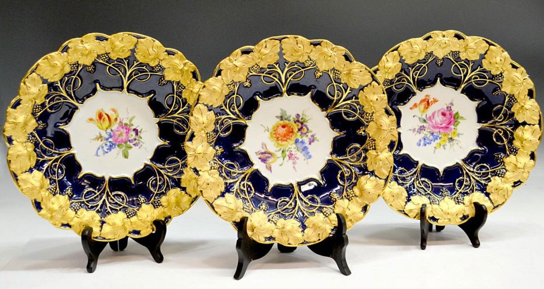 (3) FLORAL, GILT & GRAPE DECORATED MEISSEN BOWLS: (lot of 3) Meissen bowls, Germany, 20th c., having raised gilt decorated grapes, leaves and vines on a cobalt ground surrounding a floral reserve, each with blue crossed sword mark, impressed and pain