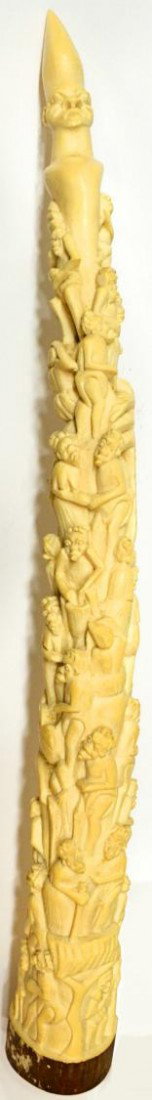 FIGURAL CARVED AFRICAN IVORY ELEPHANT TUSK, 24": **This item will not be shipped Internationally** African figural carved ivory elephant tusk, c. 1920, a large highly coifed figure at top with more than 30 figures below appearing to be climbing upwa