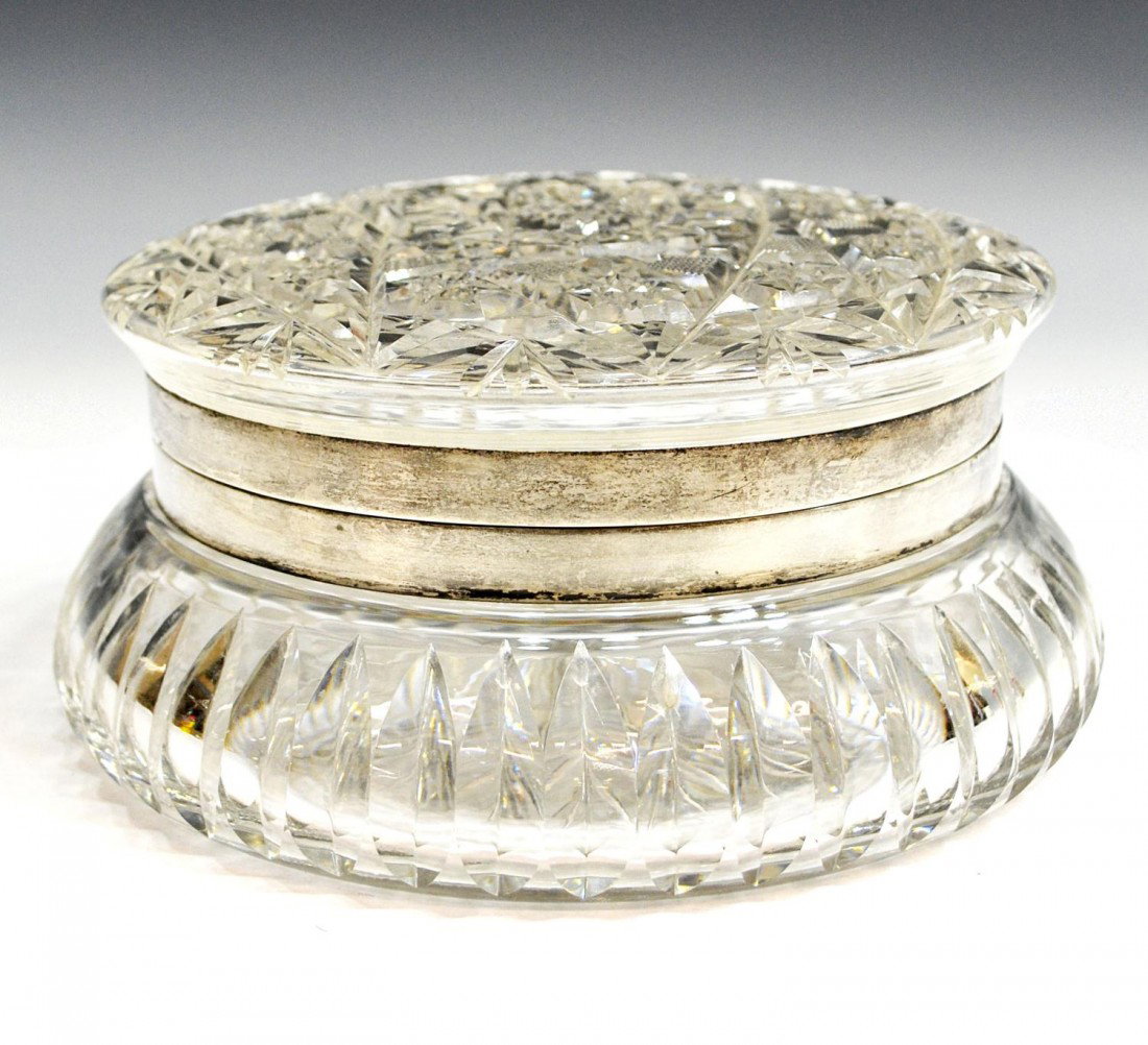 ANTIQUE AMERICAN CUT GLASS & STERLING DRESSER BOX: American cut glass dresser box of circular form, CF Monroe, Meriden, CT., c. 1900, the hinged lid and body cut in hobstar and ribbed patterns, sterling collar marked C.F. M. Co, slight wear with age, 