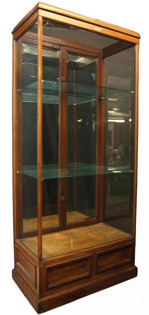 WALNUT UPRIGHT DISPLAY CABINET: Walnut upright display cabinet with two adjustable glass shelves held by screw eye hardware, rear entry thru two beveled mirror faced doors, 82.5"h, 37.75w, 21.5"d Start Price: $400.00
