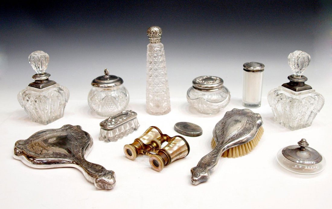 ANTIQUE & VINTAGE CUT GLASS STERLING DRESSER ITEMS: (lot) Collection of antique and vintage dresser articles, English and American examples by assorted makers, colorless cut glass dresser bottles with sterling fittings, the tallest bottle with loose ad