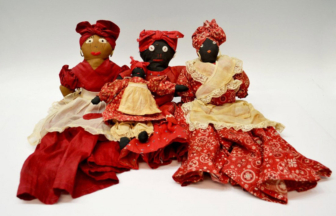 GROUP OF BLACK AMERICANA MAMMY RAG DOLLS: (lot of 4) Black Americana 'Mammy' rag dolls, each having stitched faces, applied earrings, each in traditional red and white garb, largest: 21.25"h, 11"w, 1.75lbs total Start Price: $80.00