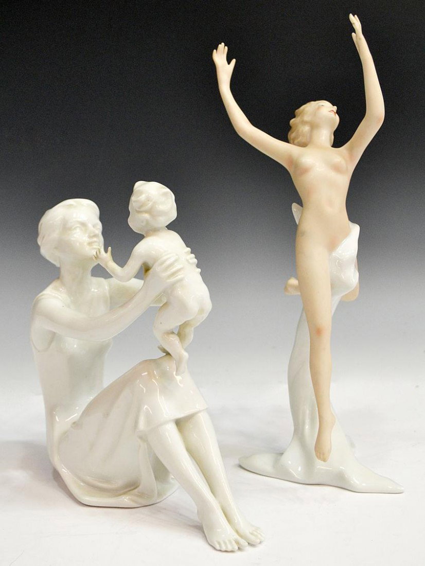 GERMAN PORCELAIN FIGURES, LEAPING NUDE & MOTHER: (lot of 2) German porcelain figures: (1) Kaiser mother and child, small black spot on corner of dress, 8.5"h, 7"l; (1) Wallendorf leaping nude, late 20th c., the partially draped figure leaping with a