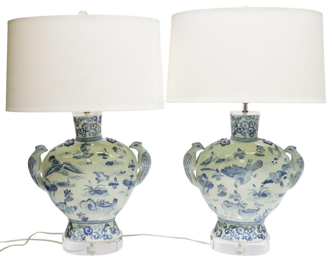 (2) CHINESE BLUE & WHITE PORCELAIN 1LT TABLE LAMPS: (pair) Chinese blue and white porcelain single-light table lamps, with figural bird handles, painted floral and bird motifs, mounted on clear acrylic base, accompanied by fabric drum shade, shade mark