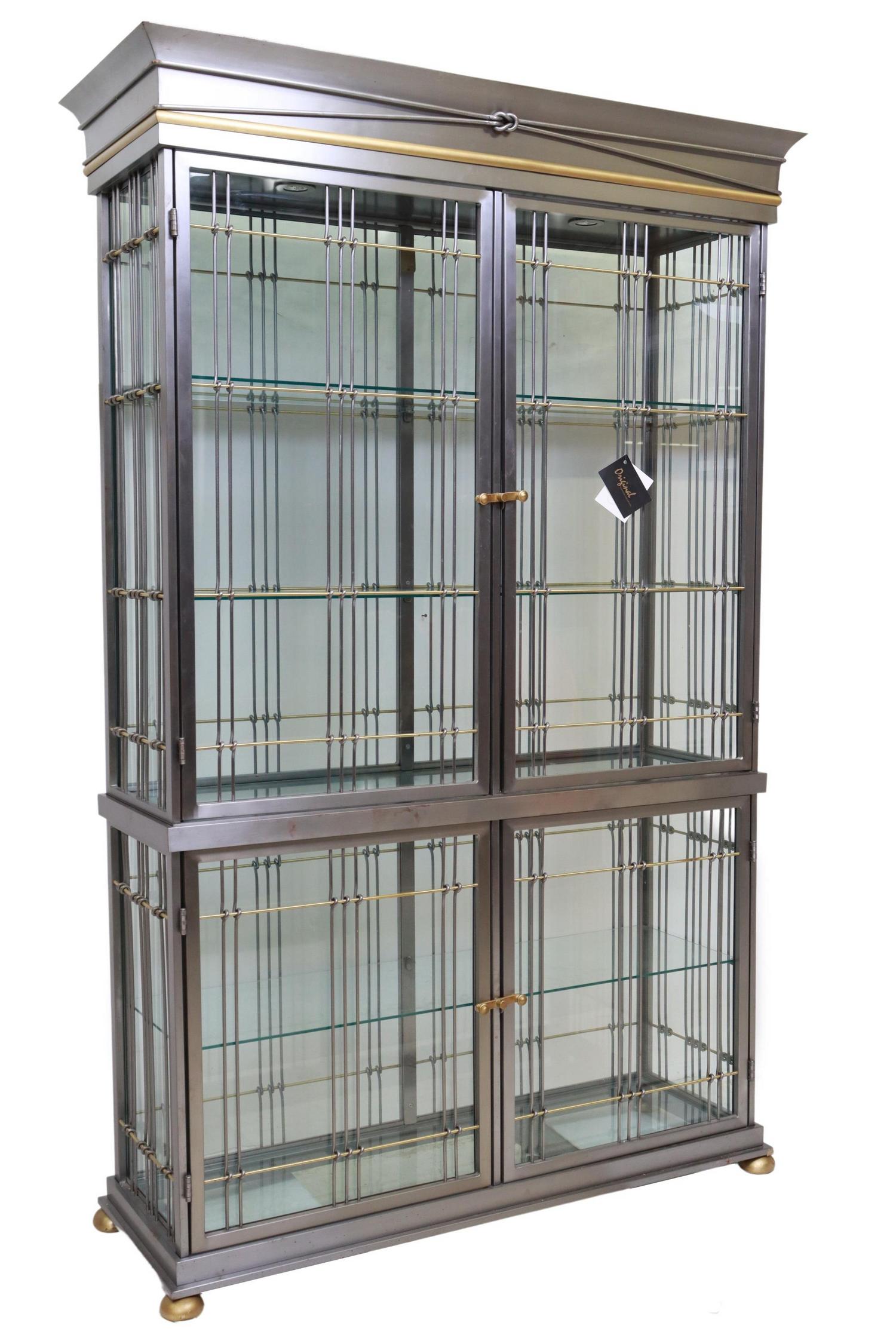 EDOARDO ORLANDI STEEL & BRASS VITRINE CABINET: Contemporary steel and brass display cabinet, Edoardo Orlandi (Italian, 20th c.), c.1970s-1980s, glazed on all sides, interior lighting, glass shelves, rising on bun feet, approx 84"h, 53.5"w, 20"d **