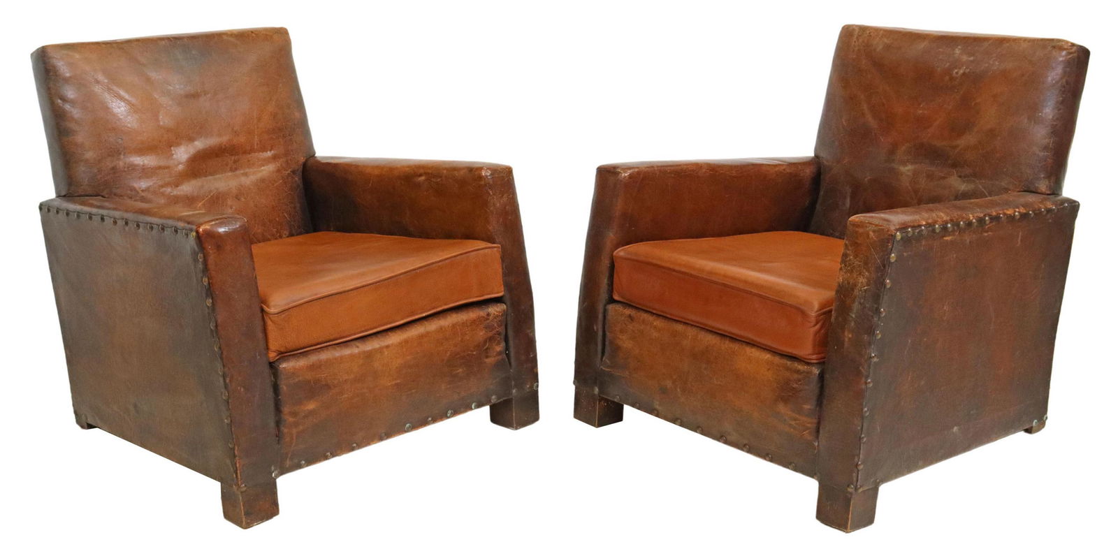 (2) FRENCH ART DECO BROWN LEATHER CLUB CHAIRS: (pair) French Art Deco leather club chairs, c. 1930s, in worn brown leather upholstery, with nailhead trim, removable seat cushion, rising on block feet, approx 31"h, 30"w, 29"d, seat height: 19"h Sta