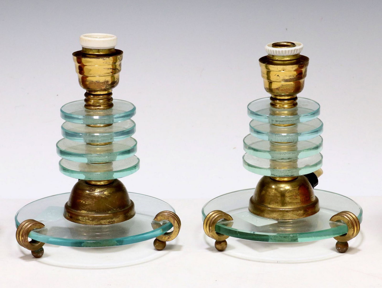 (2) ITALIAN MODERN GLASS ONE-LIGHT TABLE LAMPS: (pair) Italian modern single-light table lamps, c.1940s, having stacked colorless glass circular standard, rising on three ball feet, accompanied by later clip-on fabric shades, in need of wiring, lam