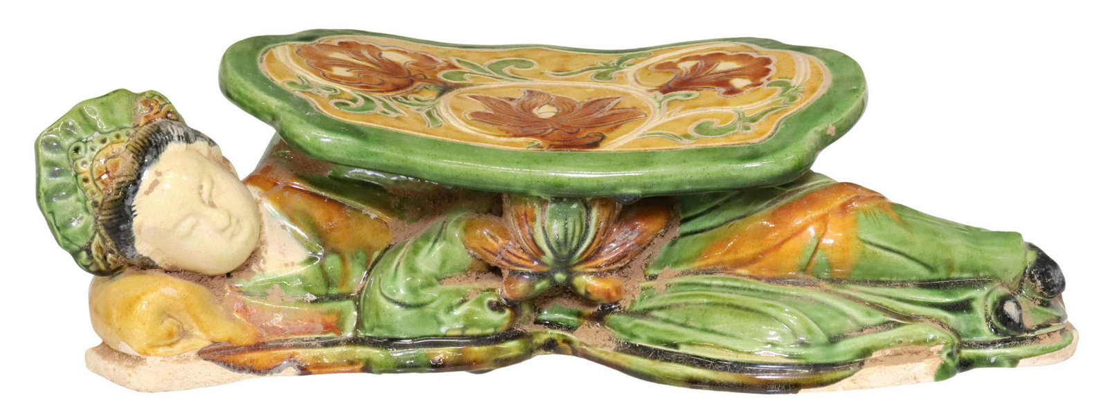 CHINESE GLAZED CERAMIC FIGURAL WOMAN NECK PILLOW: Chinese glazed ceramic figural neck pillow, in green, brown, and off-white glaze, modeled as a reclining woman, supporting a shaped headrest with scrolled foliate motifs, approx 4"h, 12"w, 5.5"d, 3.4l