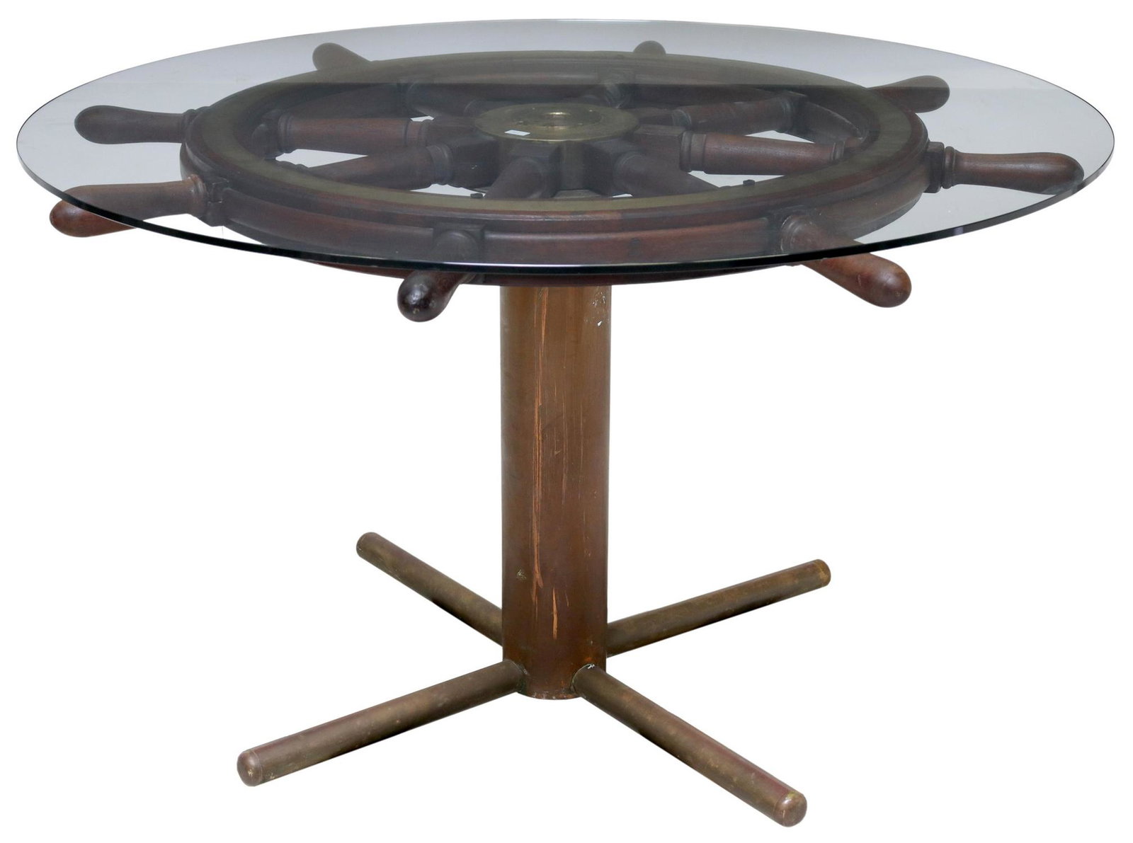 ITALIAN OAK & BRASS GLASS TOP SHIP'S WHEEL TABLE: Italian ship's wheel table, c.1920s, having glass top over oak and brass ship's helm, rising on cylindrical metal base, ending on quadripartite supports, approx 31"h, 50.75"diam **Provenance: salvaged