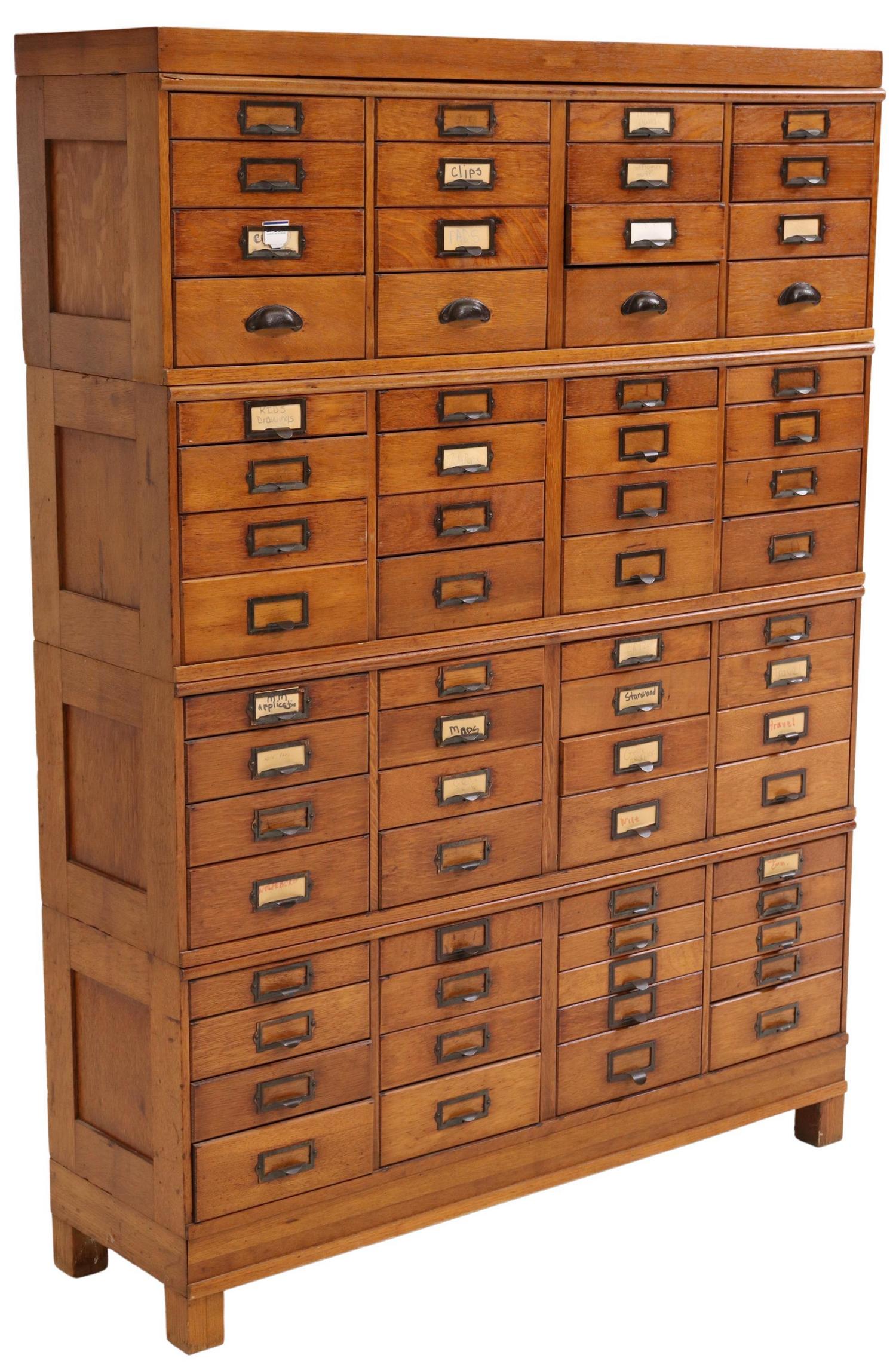 AMERICAN OAK OFFICE FILING SYSTEM CABINET: American oak filing cabinet, possibly Globe-Wernicke, early 20th c., four-section stacking unit, fitted with sixty-six drawers with hinged drawer fronts for flat filling, rising on block legs, approx 
