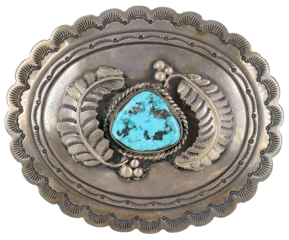 LARGE SOUTHWEST SILVER & TURQUOISE BELT BUCKLE: Southwest silver (content unknown) belt buckle, bezel-set turquoise, framed by feathers, stamped designs, approx 3.75"l, 3"w, 75 grams (inclusive of all materials) **Provenance: a private Texas collec