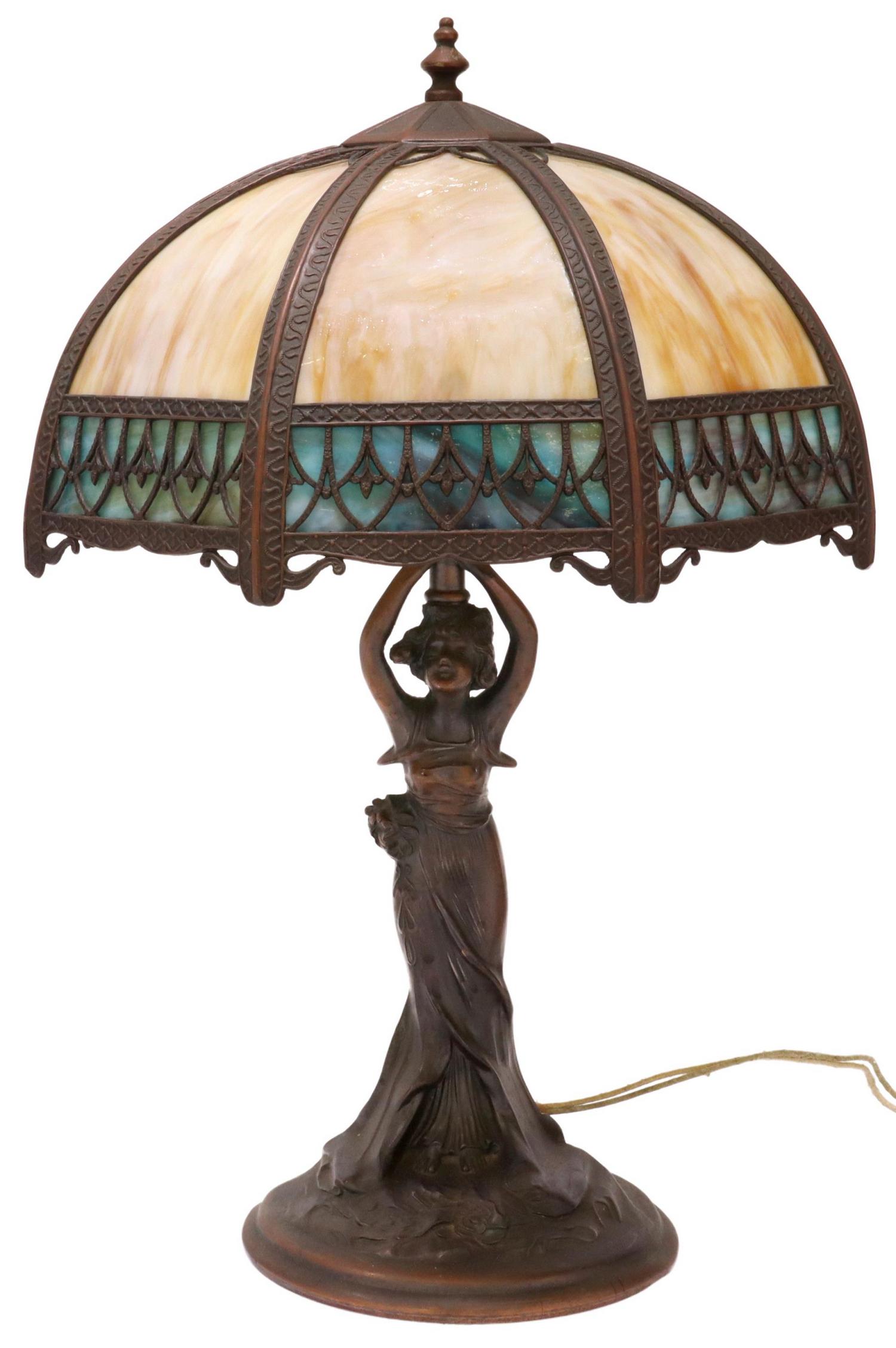 AMERICAN SLAG GLASS TWO-LIGHT FIGURAL TABLE LAMP: American slag glass table lamp, early 20th c., octagonal shade with slag glass panes, two lights, metal base in a bronze patina with female figure, (two) glass panes in border of shade intact with fra