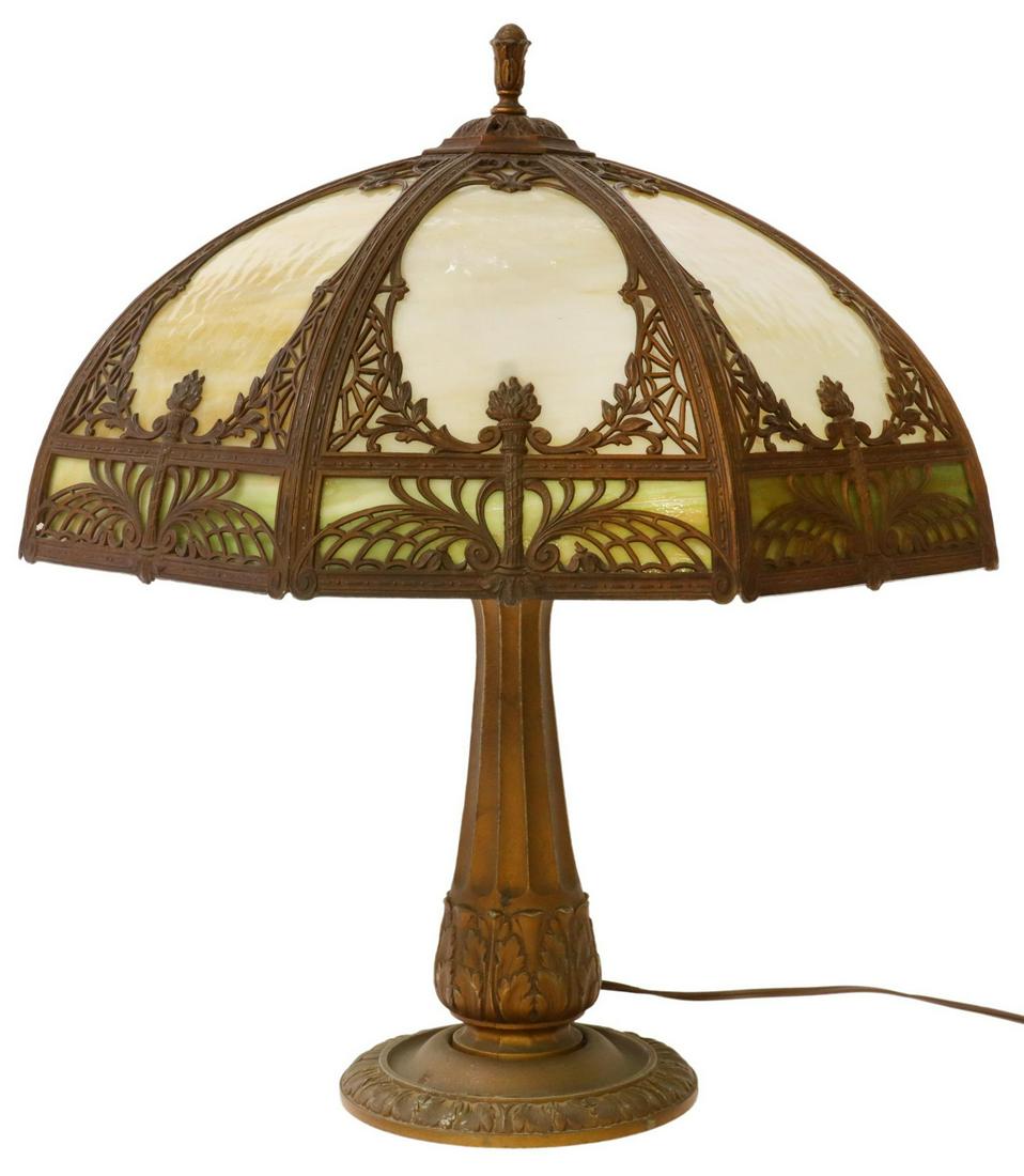 AMERICAN SLAG GLASS TWO-LIGHT TABLE LAMP: American slag glass table lamp, early 20th c., octagonal shade with slag glass panes, overlay with flaming torches, two lights, on a patinated metal base with fluted standard, acanthus leaves, approx 