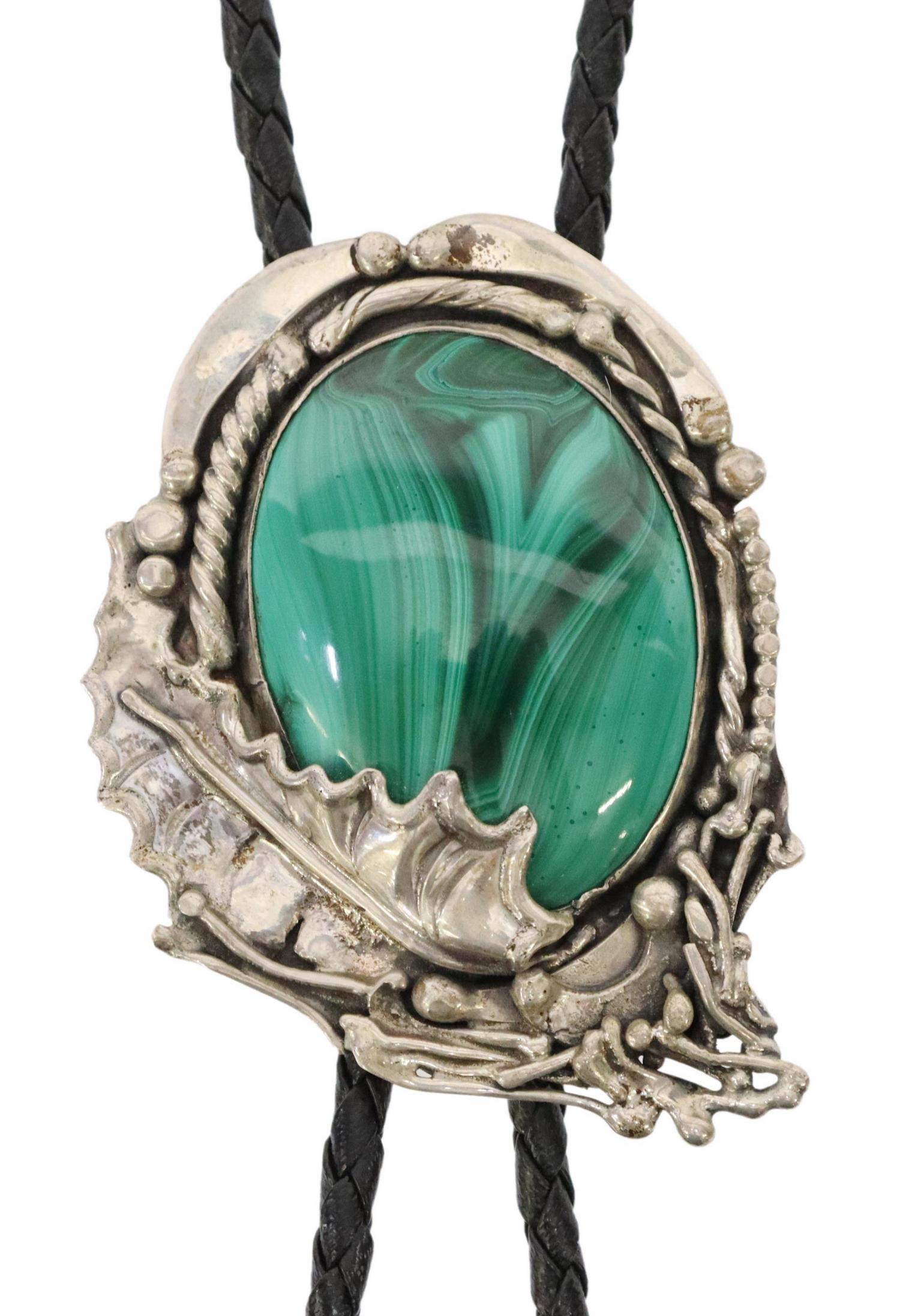 SOUTHWEST STYLE STERLING & MALACHITE BOLO TIE: Southwest style sterling silver bolo tie, Stanley Leo "Stan" Davidson (Massachusetts, 1933-2012), large malachite cabochon, silver bolo tips, on braided black leather cord, marked sterling at back of 