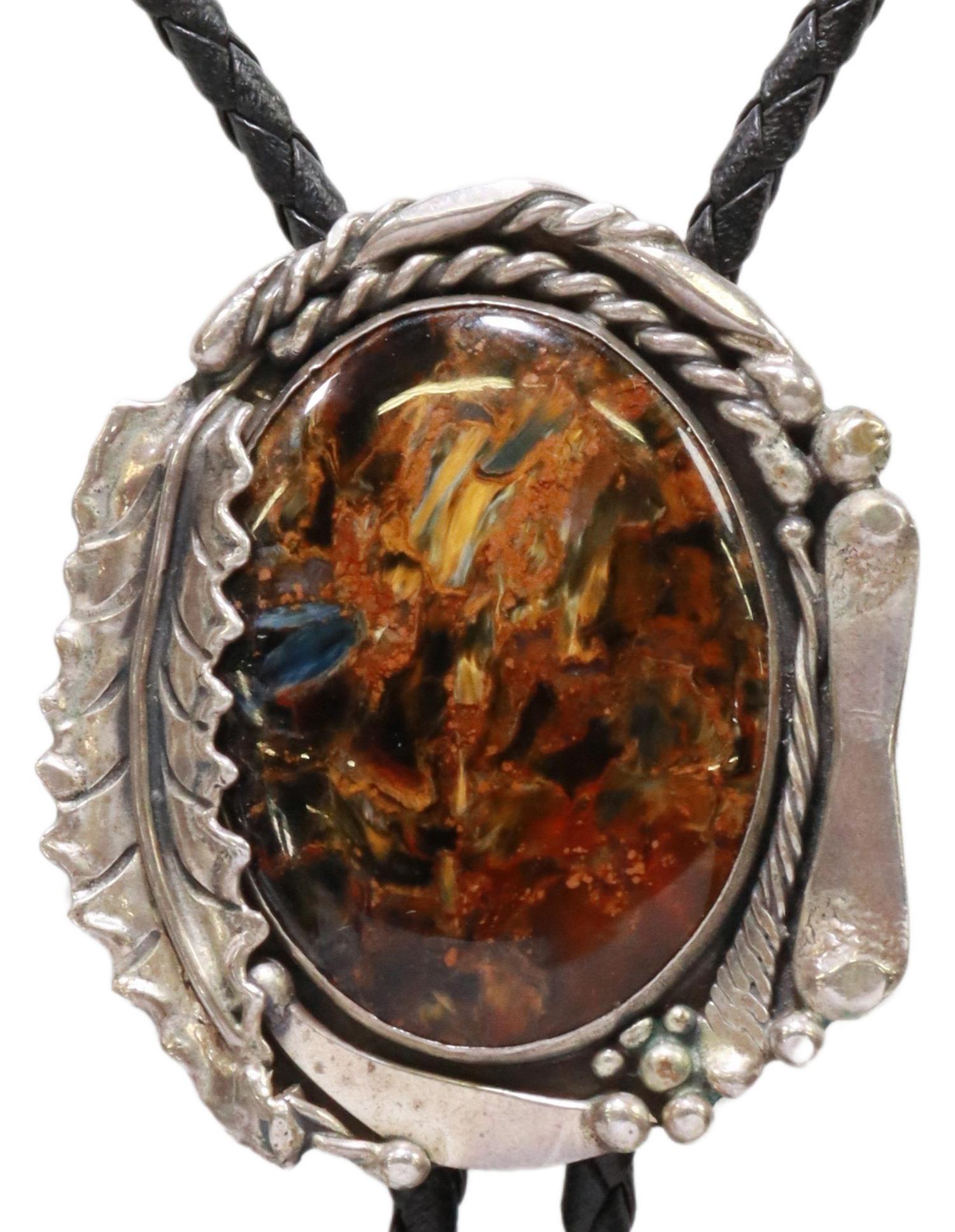 SOUTHWEST STYLE SILVER & PIETERSITE BOLO TIE: Southwest style silver (content unknown) bolo tie, Stanley Leo "Stan" Davidson (Massachusetts, 1933-2012), pietersite cabochon, silver bolo tips, on braided black leather cord, bolo ornament only: app